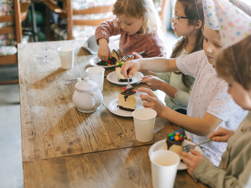Little girls enjoying a baking class and tea for a kids birthday
